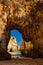 Early morning view through limestone arches on Praia Dos Tres Ir