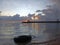 Early morning view with sunrise over the sea with calm wave water. Natural background of the beach with a tire as foreground