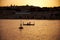 The early morning view of two people sailing in a traditional M