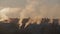 Early morning in a village with smoke rising from pipes on roofs of houses