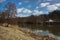 Early spring countryside. River, forest with snow remains