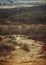 Early spring, dirt road, depressed rural landscape under a cloud