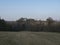 Early spring landscape at Lusatian mountains, with grass meadow, bare trees, deciduous and spruce tree forest, hills