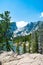 Early summer landscape with lake and snow covered mountains.