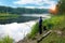 In the early summer morning, a fisherman is fishing in the upper reaches of the Volga River