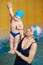 Early swimming coach training to swim baby in indoor pool