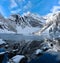 Early winter panorama of the lake and reflections of rocks on lake shore.