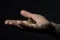 Earning money: some coins on the palm of your hardworking hand on the dark background