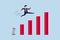 earning and profit growth jump from bottom concept, strong businessman jumping from trampoline back to top of growing bar graph