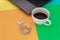 Earphones and Coffee cup with laptop a on difference colorful bright board.