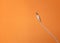 Earphones Mini Jack plug on orange  background