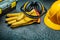 Earphones and yellow leather gloves helmet tool box