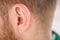 Earring in the male ear. Piercing Part of the body
