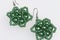 Earrings from beads handmade. Needlework at home. Bead jewelery. Green colour. On a white background.