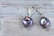 Earrings from iridescent baroque pearls on gray