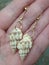 Earrings of natural shell at hand