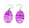Earrings in purple glass on a white background