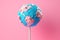 Earth depicted as a lollipop on pink background