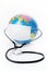 Earth globe with antiviral surgical protective face mask and stethoscope on white background. Protect planet concept.