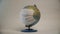 Earth globe with medical mask on white background, global pandemic covid-19, coronavirus