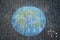 Earth globe painting with colorful chalks on ground. PHappy earth day concept. Creation of children for saving world