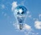 Earth globe and storm in the light bulb on a blue sky vibrant