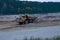 Earth mover loading dumper truck with sand in quarry. Excavator loading sand into dumper truck.Quarry for the extraction of minera