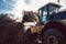 Earth mover working on pile of compost