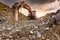 Earth moving by a bulldozer in the construction of a road in Spain. Hydraulic hammer for backhoe