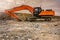 Earth moving by a bulldozer in the construction of a road in Spain. Hydraulic hammer for backhoe