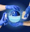 Earth planet in medical protective mask. Hand sanitizer spray, antibacterial soap, hands in latex gloves - main protective