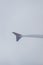 Earth in the porthole under the wing of an airplane. Flying in the fog above the clouds, nothing is visible