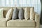 Earth tone pillows setting on light brown sofa in the living room
