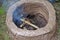 Earthen firing chamber, the replica of an ancient pit fire kiln, with lit twigs