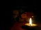 Earthen lamp lighting in the dark in worshipping room near Indian God, night photography