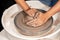 earthenware The art of sculpting clay with ceramics being molded by hand on a spinning machine. with the right posture to create a