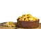 Earthenware bowl full of salted lupin beans, sitting in marble top with lupini skins. White background with copy space.