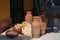 Earthenware pitchers, milk jugs at a table with traditional flat bread