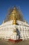 After an earthquake, the damaged, golden stupa of a pagoda in Bagan