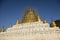 After an earthquake, the damaged, golden stupa of a pagoda in Bagan