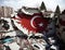 Earthquake ruined buildings with national Turkey flag on ruins, rubble and debris of buildings