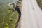 After an earthquake and strong storm in winter and severe destructive frost, asphalt road on landslide swept into sea. Closed road