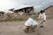 Earthquake victim man carrying stuff