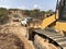 Earthworks of highland forest road. Different types of machinery on the road construction works