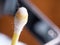 Earwax on a cotton swab, macro photo. Earwax, also known by the medical term cerumen, is a brown, orange, red, yellowish or gray