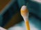 Earwax on a cotton swab, macro photo. Earwax, also known by the medical term cerumen, is a brown, orange, red, yellowish or gray