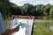 Easel artist in nature. Draw landscape from nature