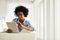 Easing into the weekend. a young woman working on her digital tablet at home.