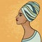 East suntanned girl in a traditional turban. Profile view.