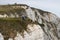 East Sussex, Beachy Head, UK 10th July 2019: People sitting extremely close to the edge off the cliff at Beachy Head